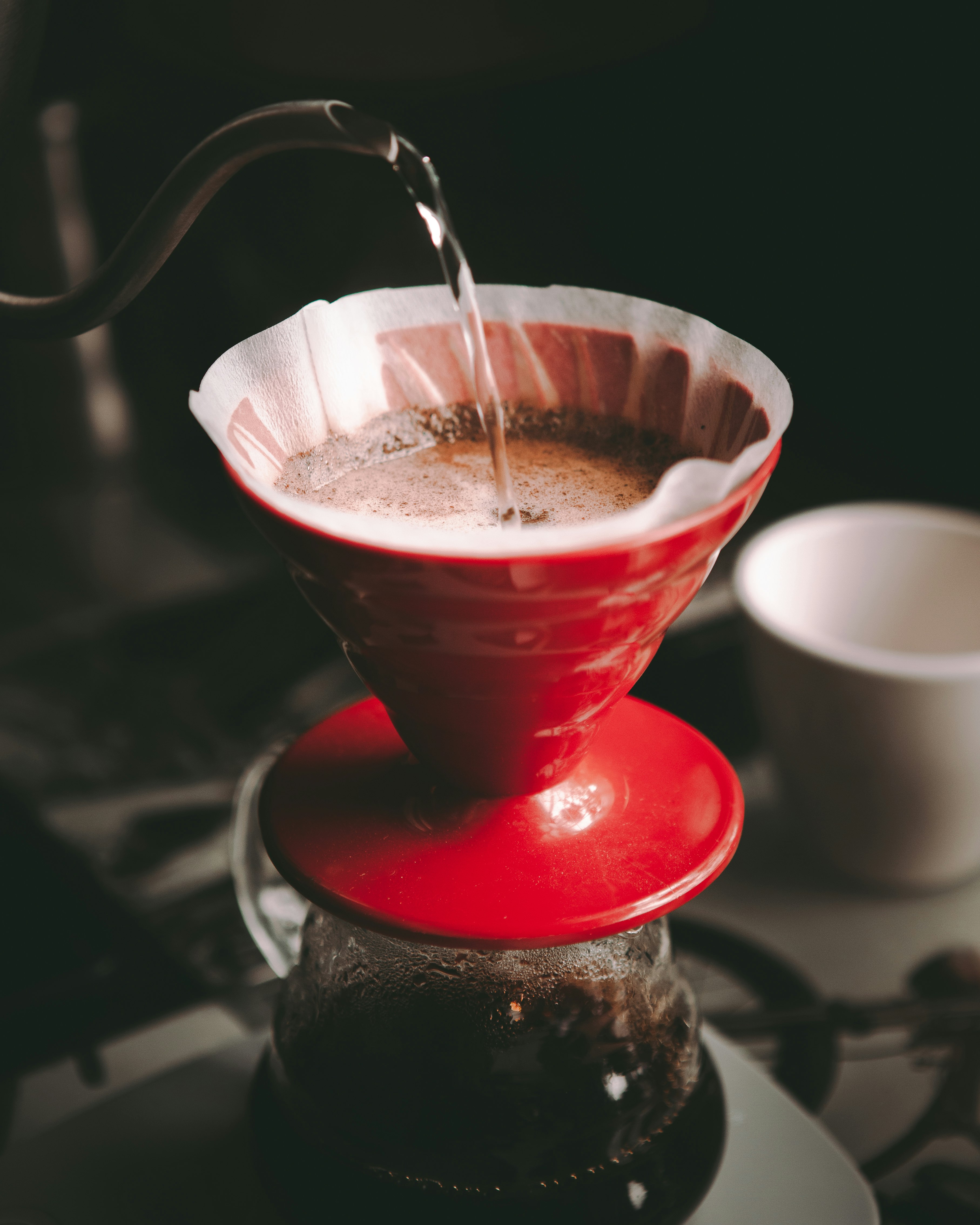 red and white ceramic cup with brown liquid